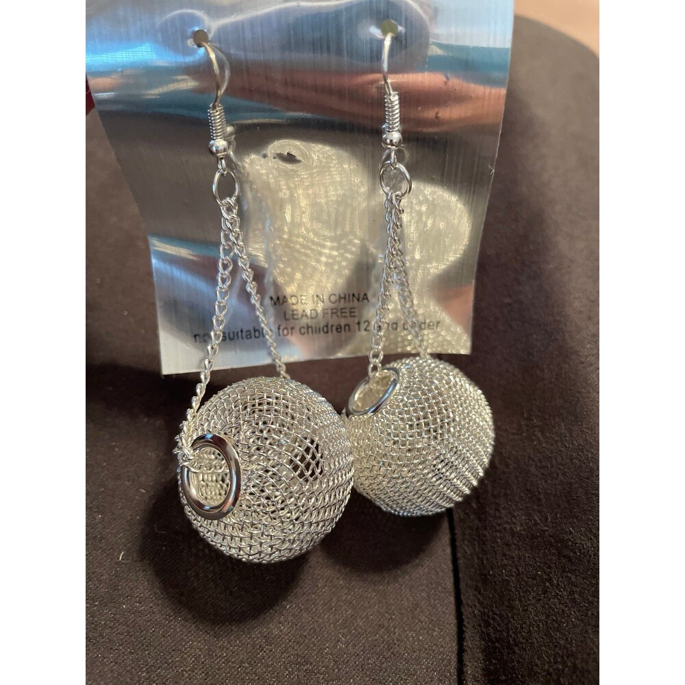 silver-toned dangle earrings featuring a hollow, textured mesh ball New